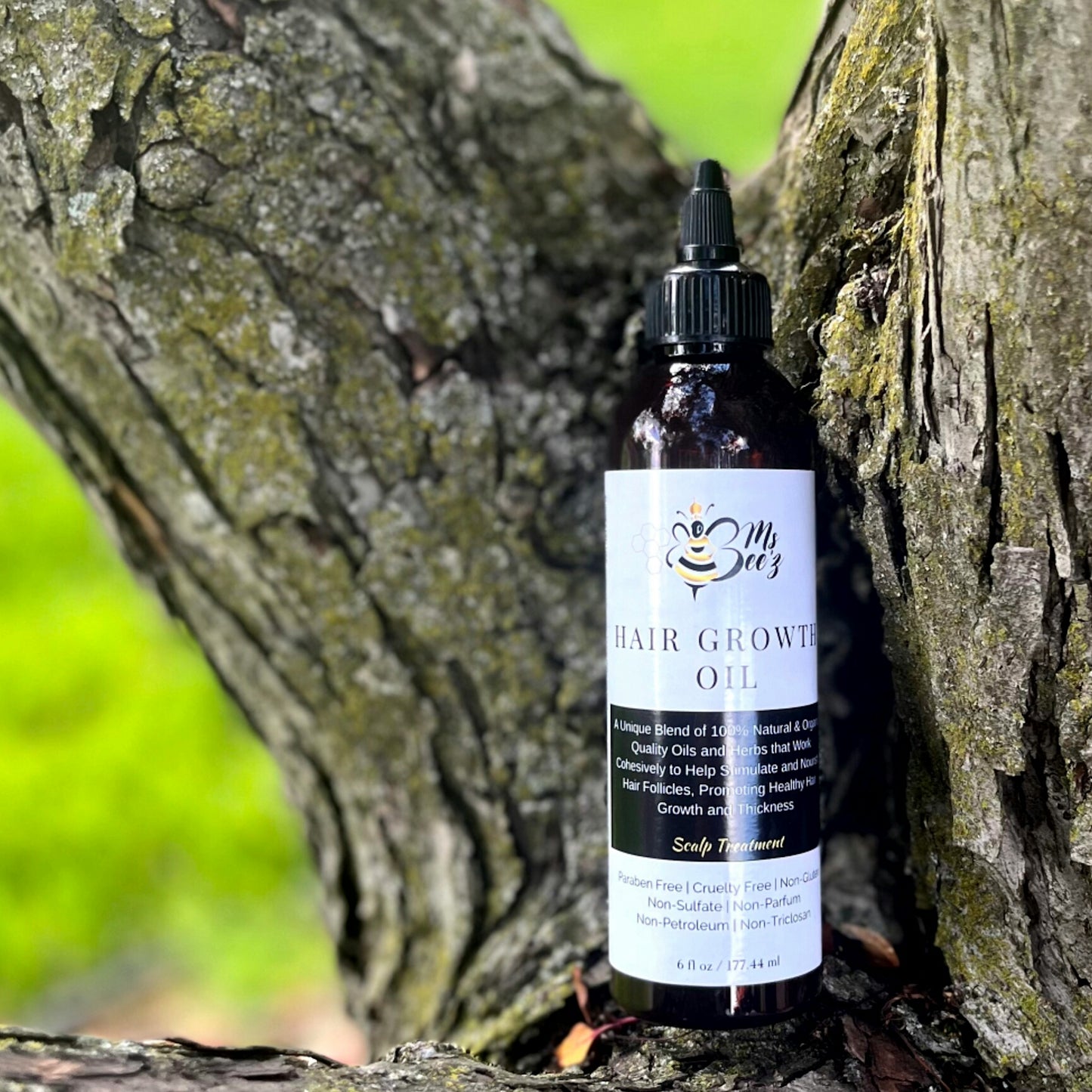 Ms beez beauty hair growth oil sitting on tree